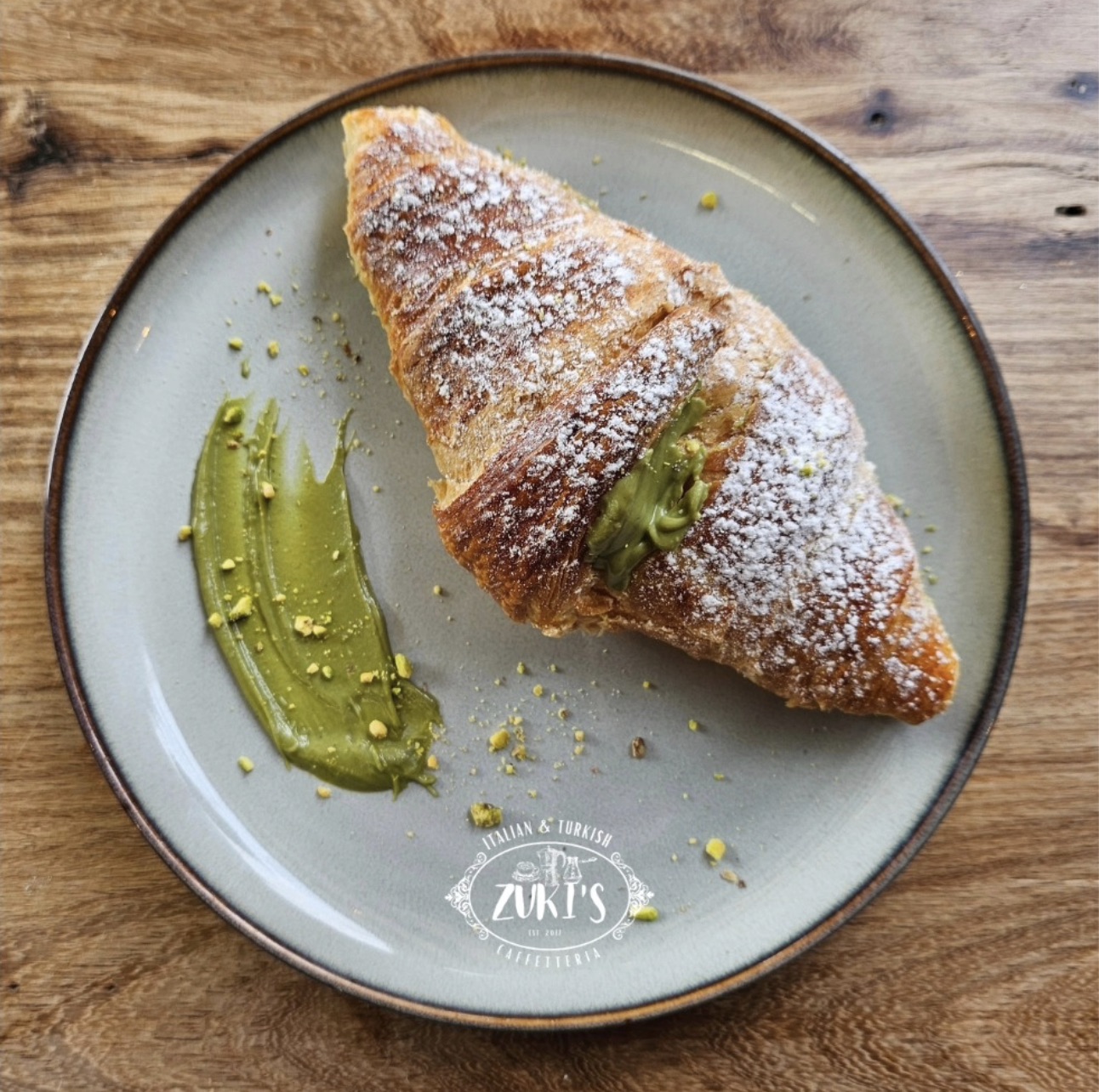 Pistachio cream croissant dusted with sugar