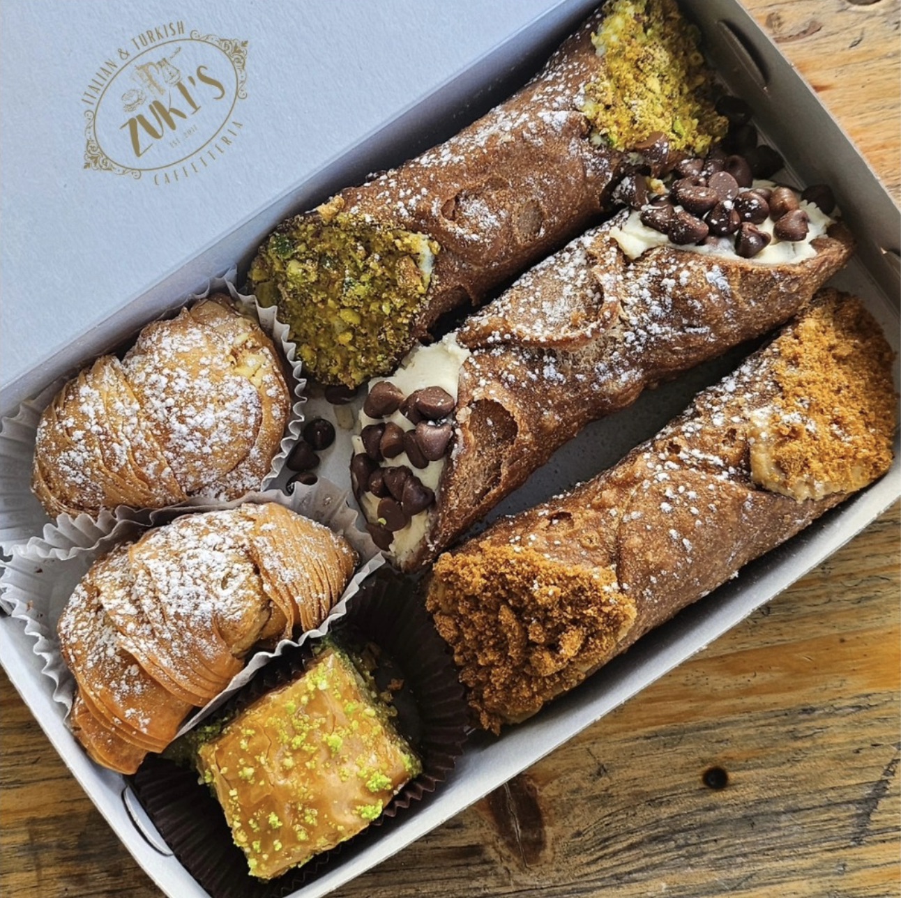 A tray of assorted cannoli and pastries